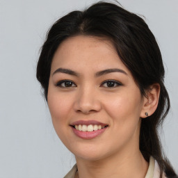 Joyful latino young-adult female with medium  brown hair and brown eyes