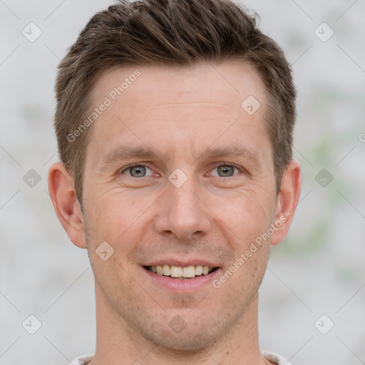 Joyful white adult male with short  brown hair and grey eyes