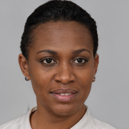 Joyful black adult female with short  black hair and brown eyes