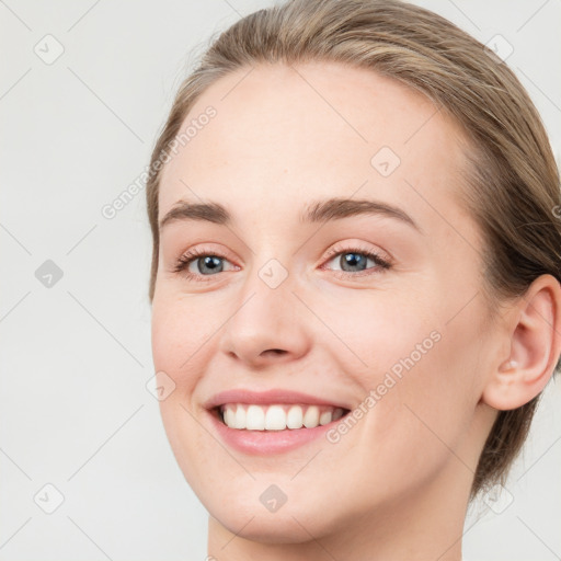 Joyful white young-adult female with medium  brown hair and blue eyes