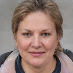 Joyful white adult female with medium  brown hair and blue eyes