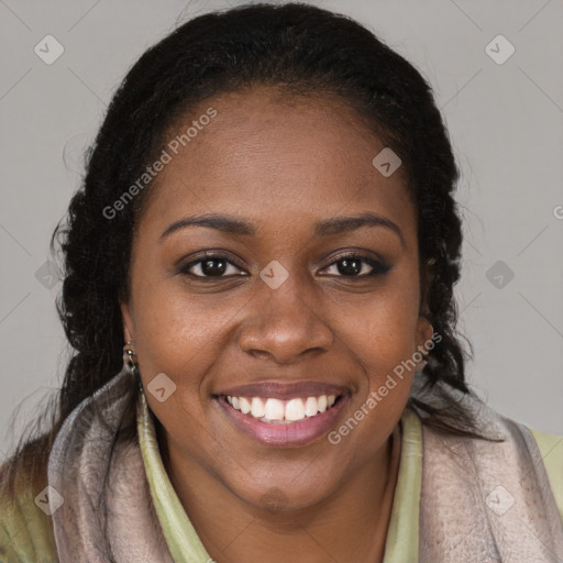 Joyful black young-adult female with long  brown hair and brown eyes