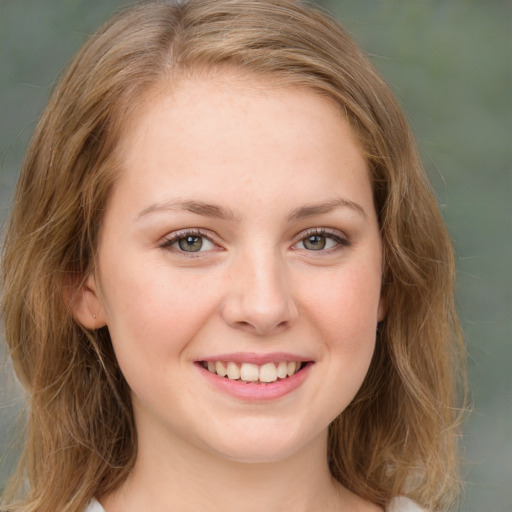 Joyful white young-adult female with medium  brown hair and green eyes