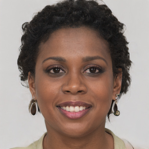 Joyful black young-adult female with short  brown hair and brown eyes