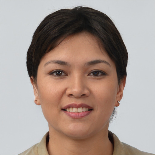 Joyful asian young-adult female with short  brown hair and brown eyes