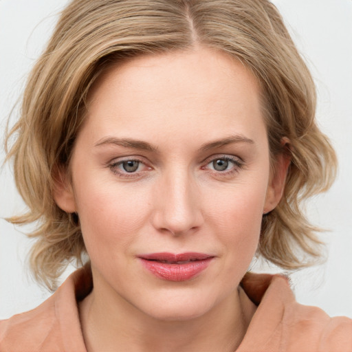 Joyful white young-adult female with medium  brown hair and blue eyes