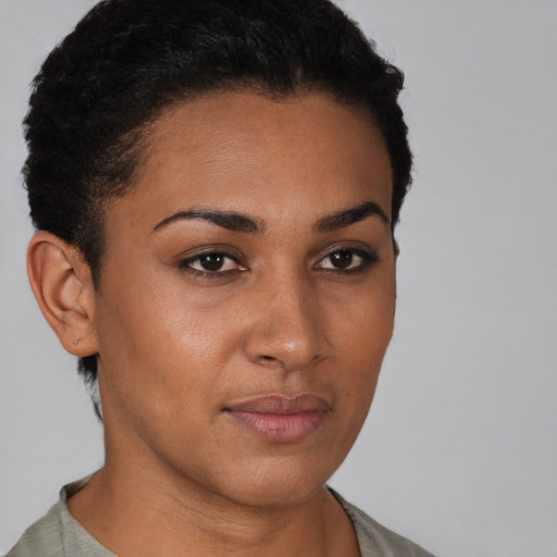 Joyful latino young-adult female with short  brown hair and brown eyes