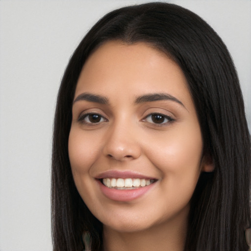 Joyful latino young-adult female with long  black hair and brown eyes