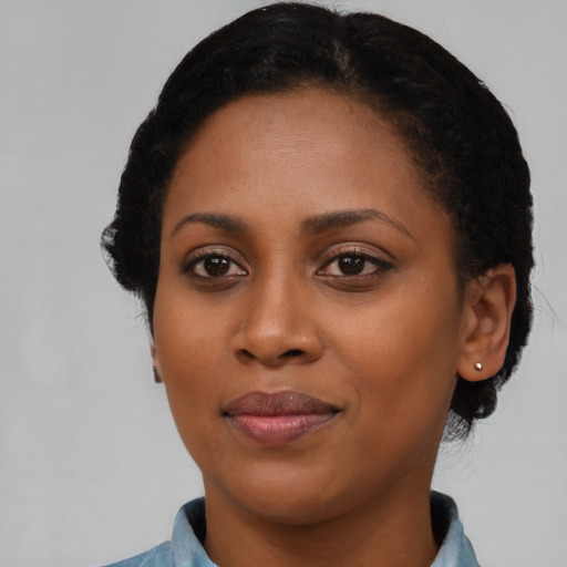 Joyful black young-adult female with medium  black hair and brown eyes