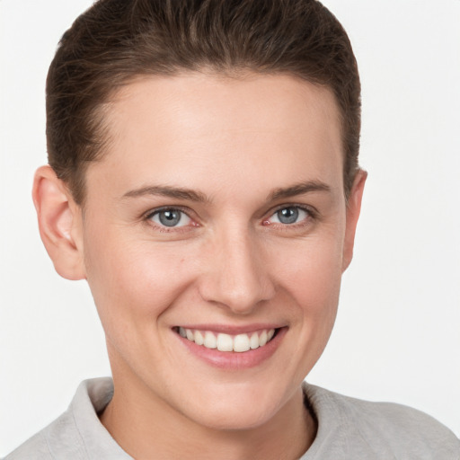 Joyful white young-adult female with short  brown hair and grey eyes