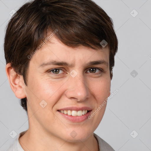 Joyful white young-adult female with short  brown hair and grey eyes