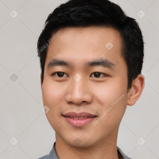 Joyful asian young-adult male with short  black hair and brown eyes