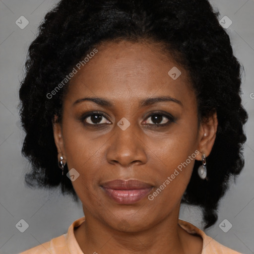 Joyful black adult female with medium  brown hair and brown eyes