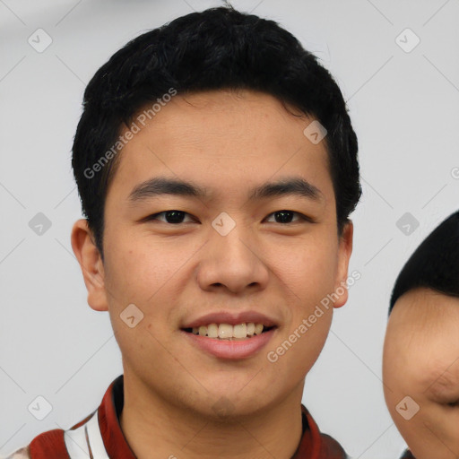 Joyful asian young-adult male with short  black hair and brown eyes