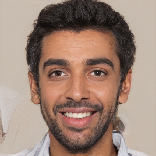 Joyful white young-adult male with short  black hair and brown eyes