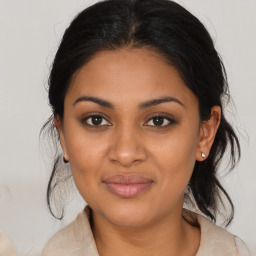 Joyful black young-adult female with medium  brown hair and brown eyes