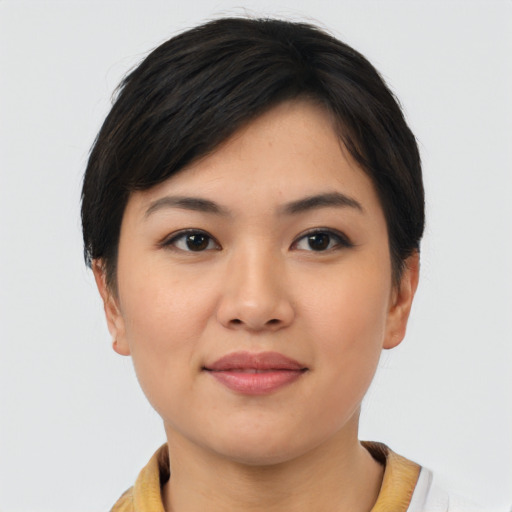 Joyful asian young-adult female with short  brown hair and brown eyes