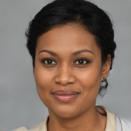 Joyful black young-adult female with medium  brown hair and brown eyes