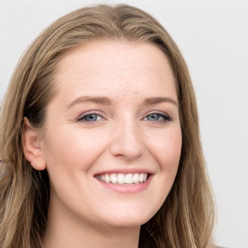 Joyful white young-adult female with long  brown hair and blue eyes