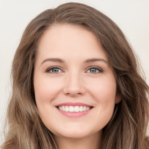 Joyful white young-adult female with long  brown hair and green eyes