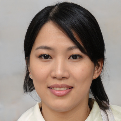 Joyful asian young-adult female with medium  black hair and brown eyes