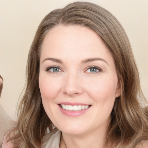 Joyful white young-adult female with medium  brown hair and grey eyes