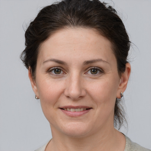 Joyful white adult female with medium  brown hair and grey eyes