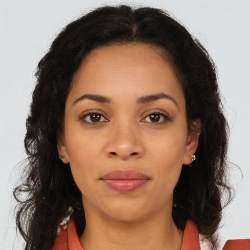Joyful latino young-adult female with long  brown hair and brown eyes
