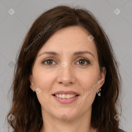 Joyful white adult female with long  brown hair and brown eyes