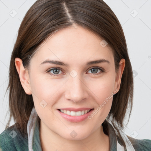 Joyful white young-adult female with medium  brown hair and grey eyes