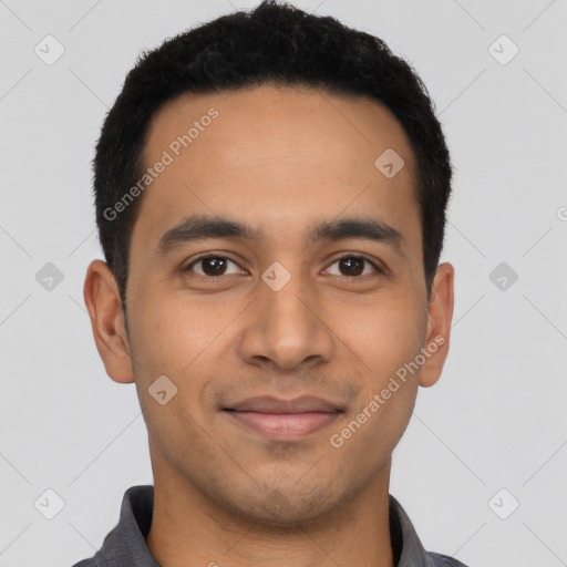 Joyful latino young-adult male with short  black hair and brown eyes