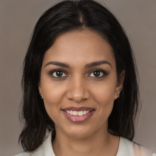 Joyful black young-adult female with medium  brown hair and brown eyes