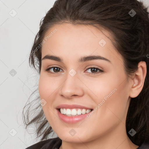 Joyful white young-adult female with long  brown hair and brown eyes