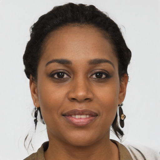 Joyful black young-adult female with short  brown hair and brown eyes