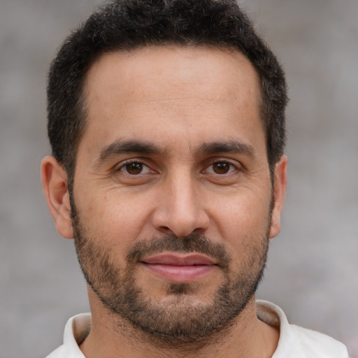 Joyful white adult male with short  brown hair and brown eyes