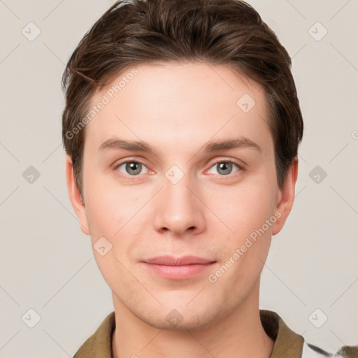 Joyful white young-adult male with short  brown hair and grey eyes