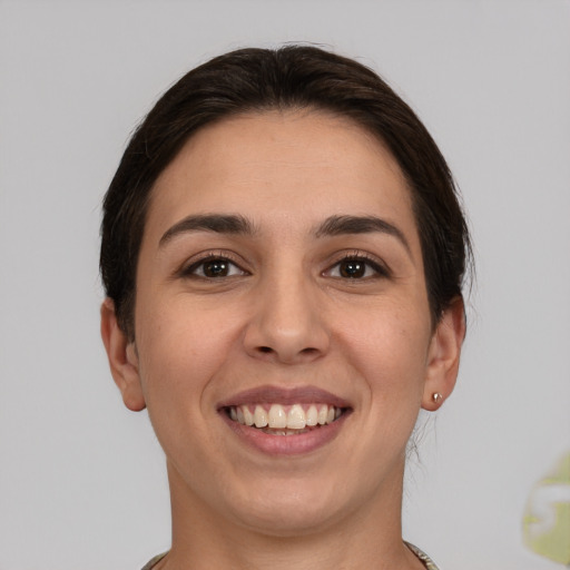 Joyful white young-adult female with short  brown hair and brown eyes