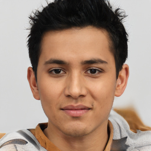 Joyful latino young-adult male with short  brown hair and brown eyes