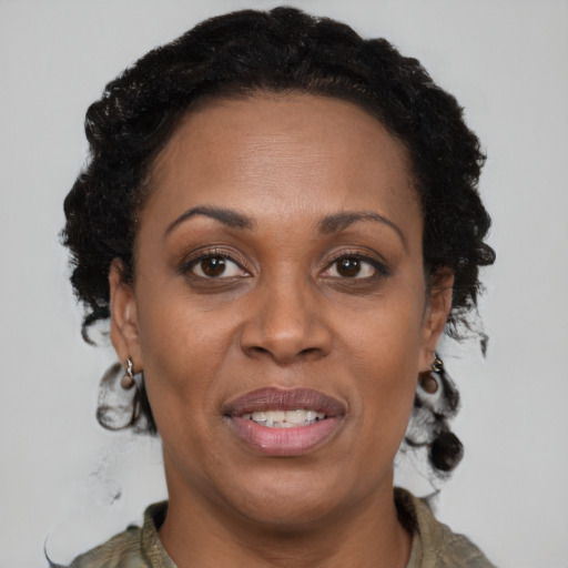 Joyful black adult female with short  brown hair and brown eyes