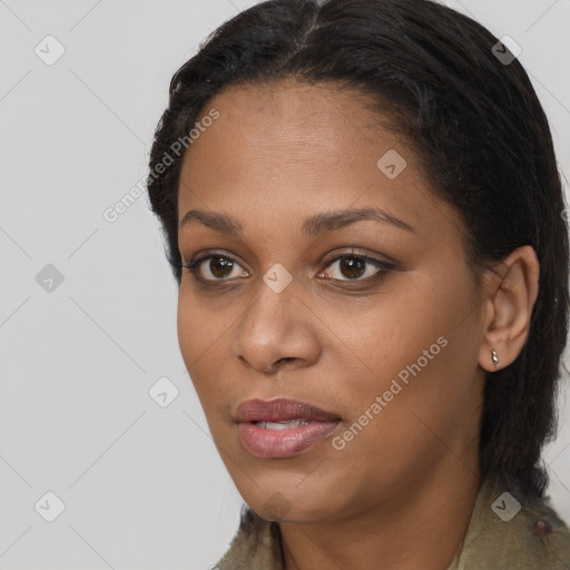 Joyful black young-adult female with long  brown hair and brown eyes