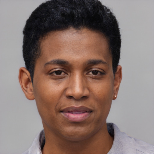 Joyful black young-adult male with short  black hair and brown eyes