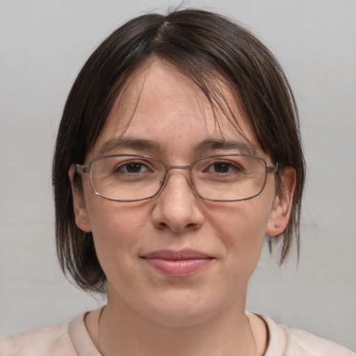 Joyful white adult female with medium  brown hair and brown eyes