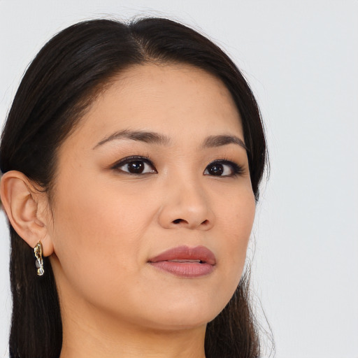 Joyful asian young-adult female with long  brown hair and brown eyes