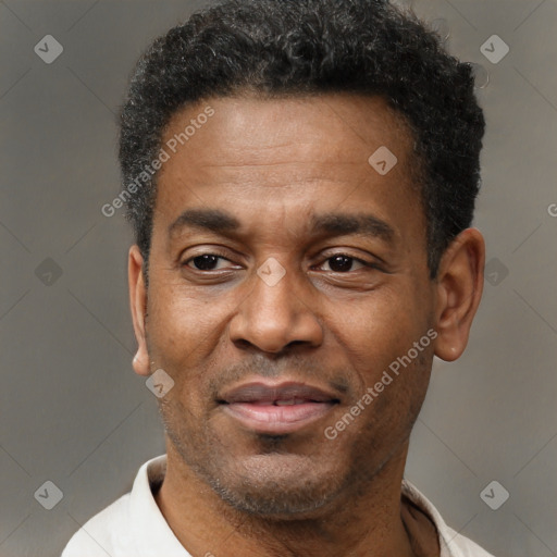 Joyful black adult male with short  black hair and brown eyes