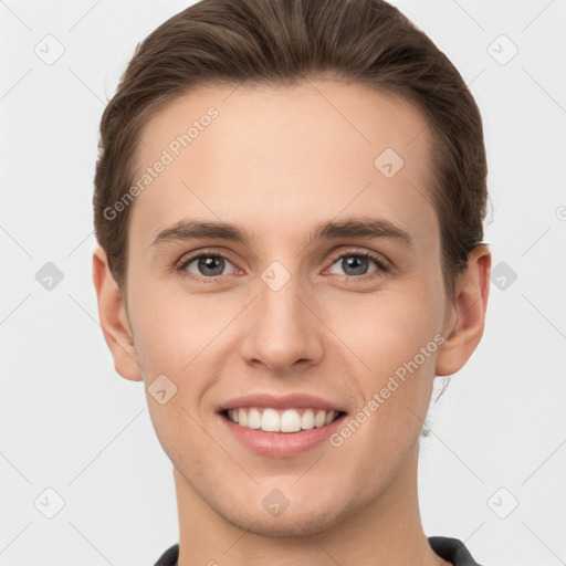 Joyful white young-adult male with short  brown hair and grey eyes