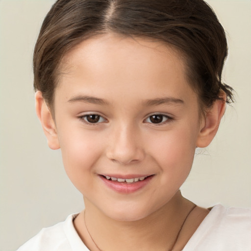 Joyful white child female with short  brown hair and brown eyes