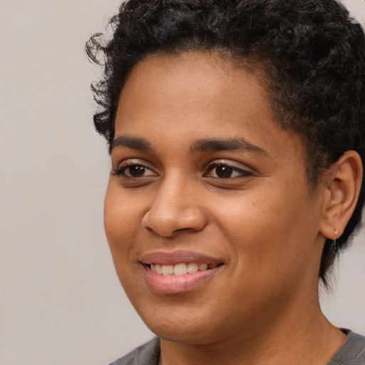 Joyful white young-adult female with short  black hair and brown eyes