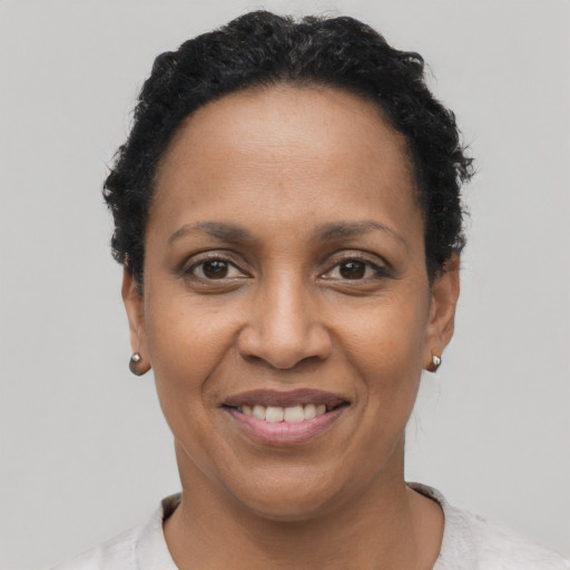 Joyful black adult female with short  black hair and brown eyes