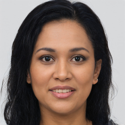 Joyful latino young-adult female with long  brown hair and brown eyes