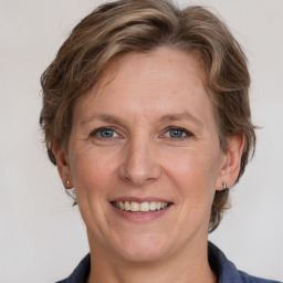 Joyful white adult female with medium  brown hair and grey eyes